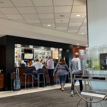 Delta Sky Club - a group of people in the lounge area - Airport Lounges Near Me - Tampa, Florida