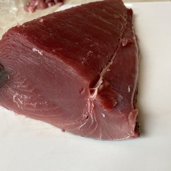 Garden & Valley Isle Seafood - a piece of meat on a cutting board - Seafood Markets Near Me - Honolulu, Hawaii