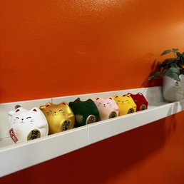a row of piggy banks on a shelf a row of piggy banks on a shelf