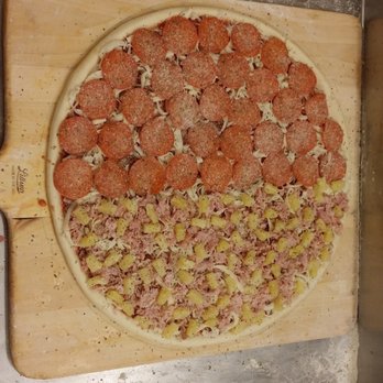 Dion's Pizza - a pepperoni pizza on a cutting board - Pizza Near Me - Los Lunas, New Mexico