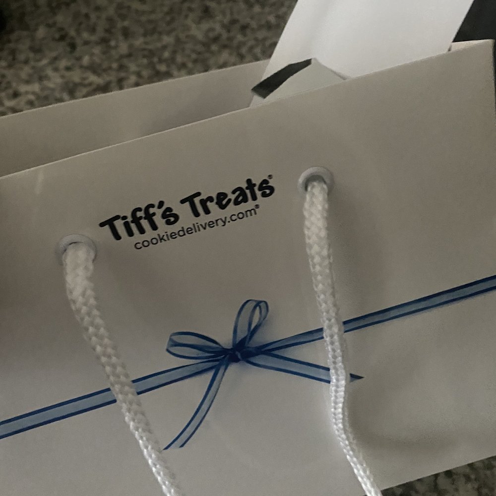Tiff's Treats - a white bag with a blue ribbon - Desserts Near Me - Addison, Texas Tiff's Treats - a white bag with a blue ribbon - Desserts Near Me - Addison, Texas