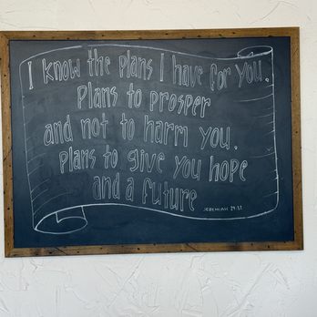 Sugarlump - Beautiful scripture displayed - A chalkboard displays a quote from Jeremiah 29:11 written in white chalk, framed with wood, mounted on a textured white wall. - Coffee & Tea Near Me - Westcliffe, Colorado