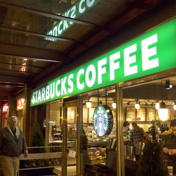 Starbucks - people walking in front of a starbucks coffee shop - Coffee & Tea Near Me - Vancouver, British Columbia Starbucks - people walking in front of a starbucks coffee shop - Coffee & Tea Near Me - Vancouver, British Columbia