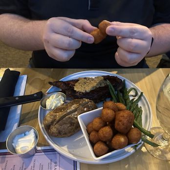 Reel Seafood Grill - New York Strip with hush puppies, green beans and baked potato - Seafood Near Me - Greensboro, North Carolina Reel Seafood Grill - New York Strip with hush puppies, green beans and baked potato - Seafood Near Me - Greensboro, North Carolina