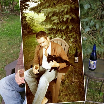 Sparkling Pond Winery - a man sitting in a chair holding a cat - Wineries Near Me - Ripley, New York Sparkling Pond Winery - a man sitting in a chair holding a cat - Wineries Near Me - Ripley, New York