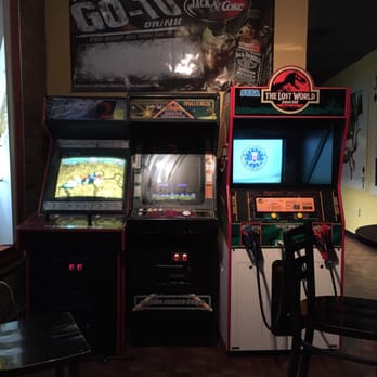 Play - a row of video game machines in a room - Bars Near Me - Pensacola, Florida Play - a row of video game machines in a room - Bars Near Me - Pensacola, Florida