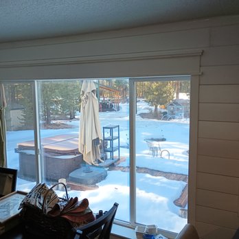 Stone Fire Construction and Maintenance - a view of a patio through a sliding glass door - General Contractors Near Me Stone Fire Construction and Maintenance - a view of a patio through a sliding glass door - General Contractors Near Me