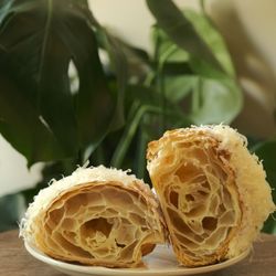 Kora - Ensaymada Croissant. Buttery, flakey ensaymada, sugared butter, Edam Cheese.