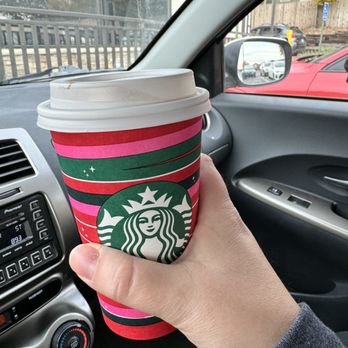 Starbucks - a hand holding a cup of coffee in a car - Coffee & Tea Near Me - Mission, Kansas Starbucks - a hand holding a cup of coffee in a car - Coffee & Tea Near Me - Mission, Kansas