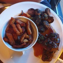 Steak with a great sauce, brussel sprouts and fries