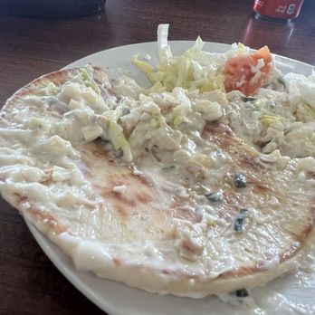 Jefferson Park Grill - Chicken gyro - A pizza with a white sauce base, topped with shredded lettuce and small pieces of chicken, served on a white plate. - New American Near Me - Chicago, Illinois