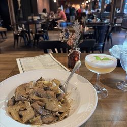 Dry Diggings Distillery - Showing off my pasta dish, along with the strawberry fields cocktail and the cute ambience beyond.