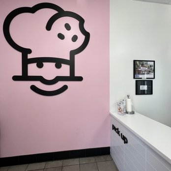 Crumbl - Natomas - a chef's face on a pink wall - Bakeries Near Me - Sacramento, California Crumbl - Natomas - a chef's face on a pink wall - Bakeries Near Me - Sacramento, California
