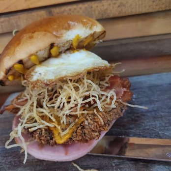 Heist Brewery - Breakfast Burger with fried chicken substituted for the beef patty - New American Near Me - Charlotte, North Carolina