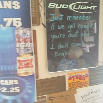 K Bar - a man sitting in front of a sign - American Near Me - Cumberland, Maryland