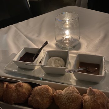 Queenie's Steakhouse - a plate of donuts and dipping sauces - Steakhouses Near Me - Denton, Texas Queenie's Steakhouse - a plate of donuts and dipping sauces - Steakhouses Near Me - Denton, Texas