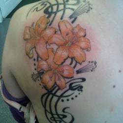 Tribal Images - Lily and tribal style back tattoo. Done by Lacey, 2009.