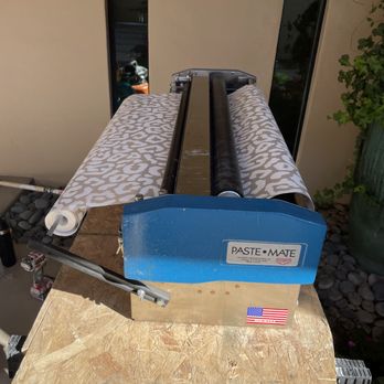 Innovare Drywall - Here we are prepping the wall paper to be ready to be applied to the walls. - Drywall Installation & Repair Near Me
