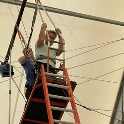 Dallas Circus Center - My husband at the top of the trapeze getting harnessed in for the flying