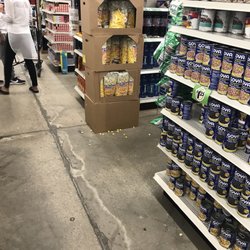 Dollar Tree - Food particles scattered across floor. Dirty floors and shelves. Unclean.