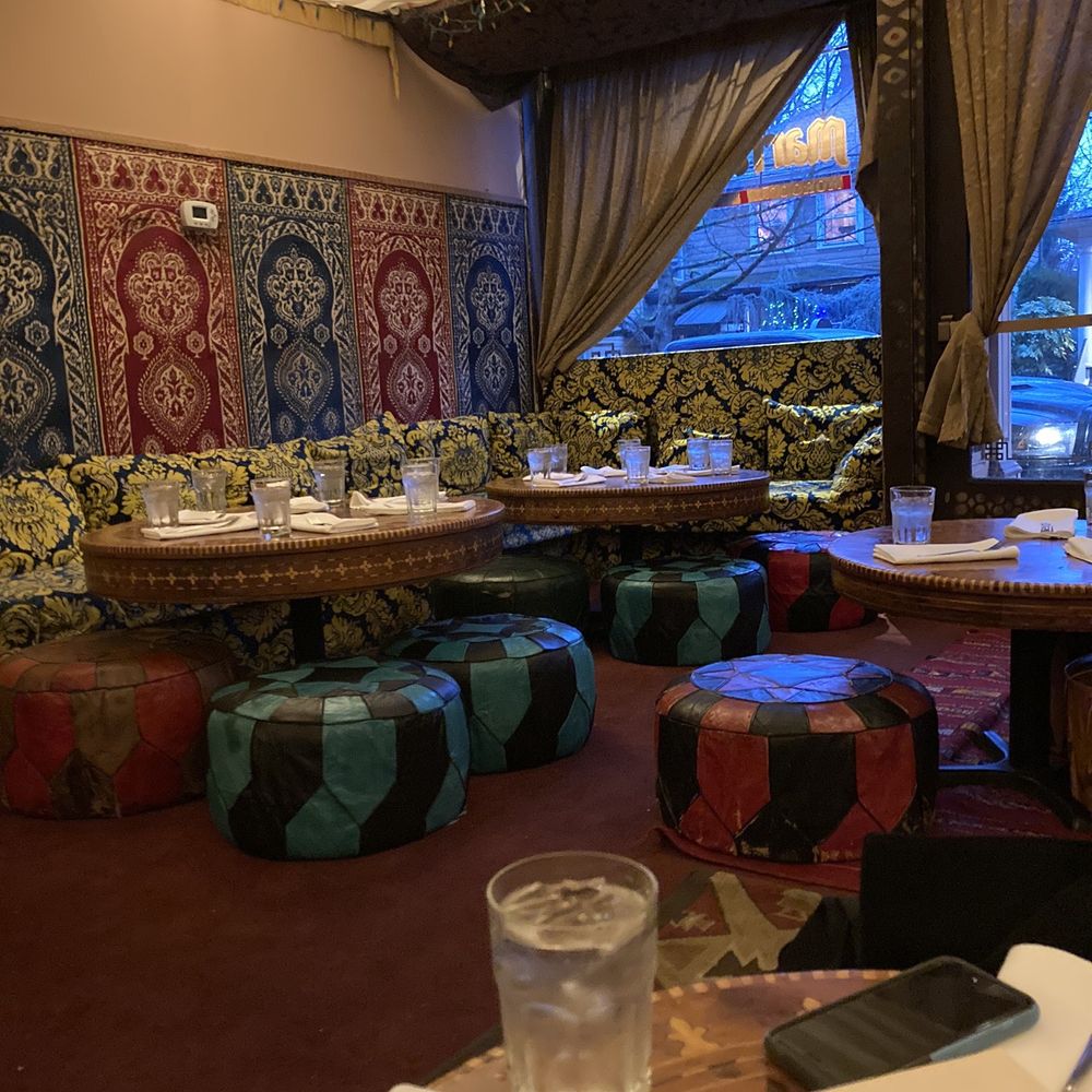 Marrakesh Restaurant - The inside. At a closer look throughout some of the chairs are pretty worn and the drapes above have water stains from leaks - Moroccan Near Me - Portland, Oregon
