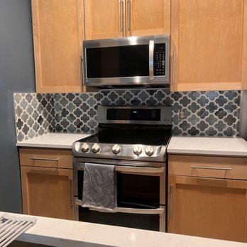 Lightning Remodel - a kitchen with stainless steel appliances - Flooring Near Me