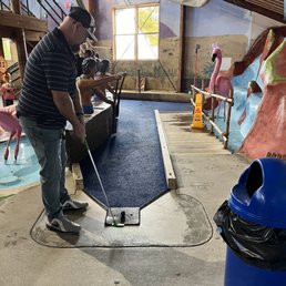 Enjoying an afternoon of mini golf at the indoor course.