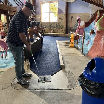 Old Pro Golf - Enjoying an afternoon of mini golf at the indoor course. - Mini Golf Near Me - Ocean City, Maryland