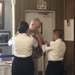Our children pinning their daddy for his promotion.