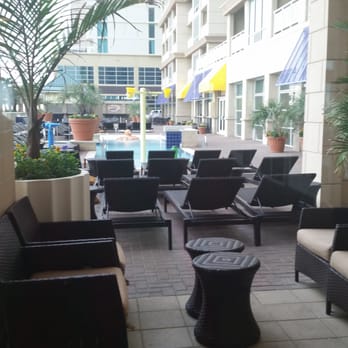 Oceanaire Resort - Lounging outdoors...outdoor pool. Outside entrance into Ocean Beach Club's indoor is this way - Hotels Near Me - Virginia Beach, Virginia