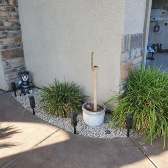 Start Fresh Landscaping - a planter and a fire hydrant in front of a house - Landscaping Near Me