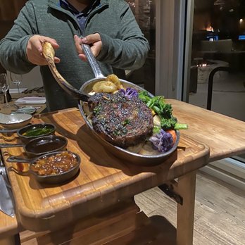 Valley Kitchen - Our 28 ounce Tomahawk Steak being carved table-side by the Restaurant Manager. Carmel Valley Ranch Tomahawk Experience. - New American Near Me - Carmel, California Valley Kitchen - Our 28 ounce Tomahawk Steak being carved table-side by the Restaurant Manager. Carmel Valley Ranch Tomahawk Experience. - New American Near Me - Carmel, California