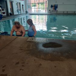 Franklin County Family YMCA - Husband and therapist working together on aquatic therapy