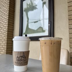 Sunergos Coffee - Hot oat milk latte and an iced latte