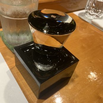 Matoi - They over pour the Sake into a box so once you empty the glass you pour the excess from the box for a second serving. - Sushi Bars Near Me - San Diego, California Matoi - They over pour the Sake into a box so once you empty the glass you pour the excess from the box for a second serving. - Sushi Bars Near Me - San Diego, California
