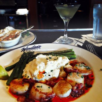 Winston's Grille - Scallops with bacon in red pepper sauce with cheese grits and asparagus - American Near Me - Raleigh, North Carolina Winston's Grille - Scallops with bacon in red pepper sauce with cheese grits and asparagus - American Near Me - Raleigh, North Carolina