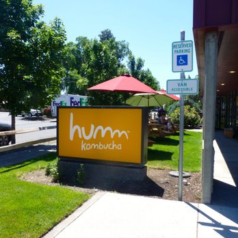 Humm Kombucha - behind sign you can see shaded picnic tables if you want to enjoy your beverages outside. - Breweries Near Me - Bend, Oregon Humm Kombucha - behind sign you can see shaded picnic tables if you want to enjoy your beverages outside. - Breweries Near Me - Bend, Oregon