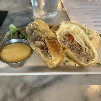 The Oysterman - Oysterman Egg Rolls -- seared steak, american and cheddar cheese, peppers, onions, maple dijon dipping sauce - Seafood Near Me - Duxbury, Massachusetts The Oysterman - Oysterman Egg Rolls -- seared steak, american and cheddar cheese, peppers, onions, maple dijon dipping sauce - Seafood Near Me - Duxbury, Massachusetts