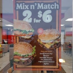 a sign in the window of a fast food restaurant