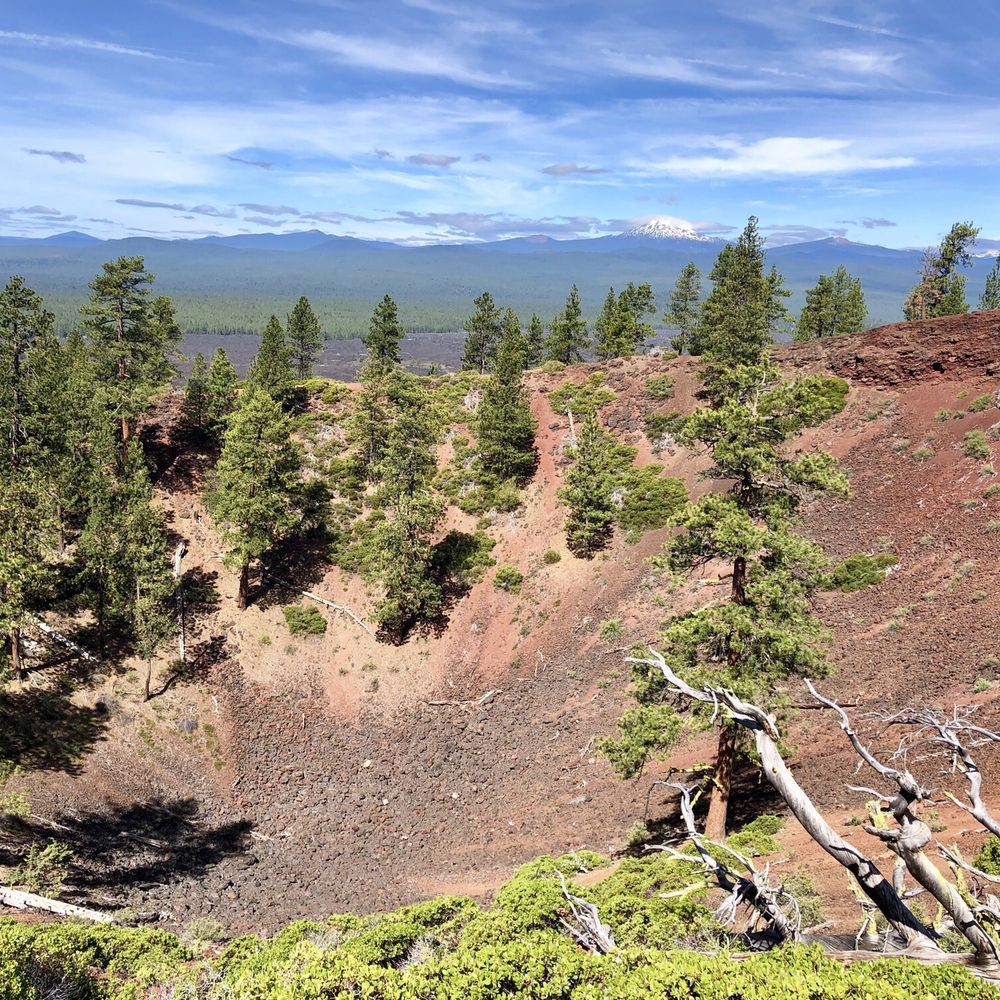 Newberry National Volcanic Monument - Mt. Bachelor looms in the distance of the Lava Butte crater (one of the volcano's cinder cones that erupted 7,000 years ago) - Landmarks & Historical Buildings Near Me - Bend, Oregon Newberry National Volcanic Monument - Mt. Bachelor looms in the distance of the Lava Butte crater (one of the volcano's cinder cones that erupted 7,000 years ago) - Landmarks & Historical Buildings Near Me - Bend, Oregon