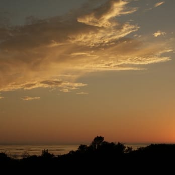 Sand Pebbles Inn - Sunset from the deck of Seascape Cottage - Hotels Near Me - Cambria, California Sand Pebbles Inn - Sunset from the deck of Seascape Cottage - Hotels Near Me - Cambria, California