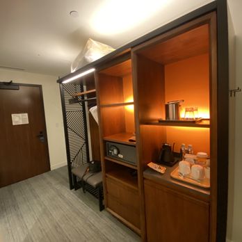 The Ameswell Hotel - Entryway with bench, open closet, safe, mini fridge, etc. - Venues & Event Spaces Near Me - Mountain View, California The Ameswell Hotel - Entryway with bench, open closet, safe, mini fridge, etc. - Venues & Event Spaces Near Me - Mountain View, California