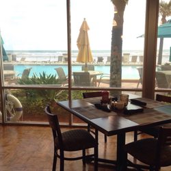 Reflections - The dining area overlooks the hotel pool & Atlantic Ocean