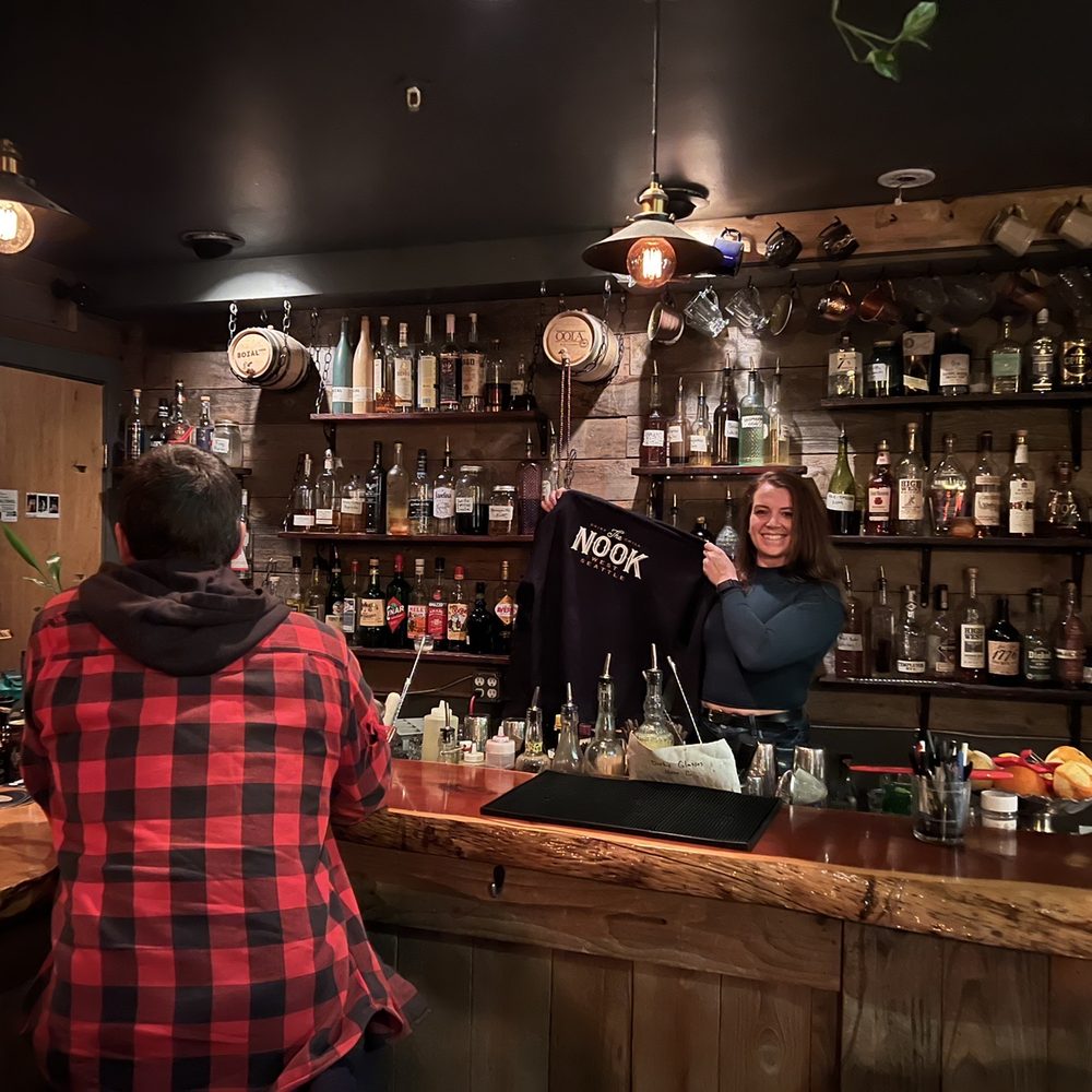 The NOOK - a man and a woman behind a bar - Lounges Near Me - Seattle, Washington