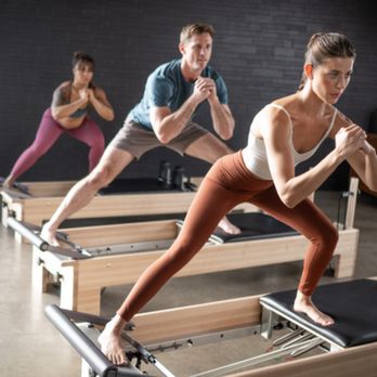 Elevate Pilates - Elevate Pilates - clients performing a side lunge on a Pilates reformer - Pilates Near Me - Aliso Viejo, California Elevate Pilates - Elevate Pilates - clients performing a side lunge on a Pilates reformer - Pilates Near Me - Aliso Viejo, California