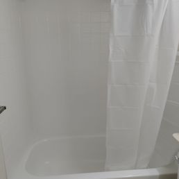 Simple curtain instead of the glass sliding door.  Simple and clean.