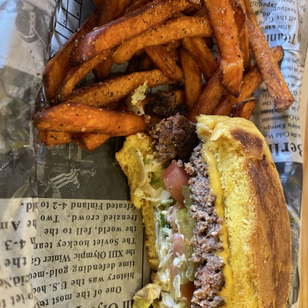 Half of my burger and sweet potato fries Half of my burger and sweet potato fries