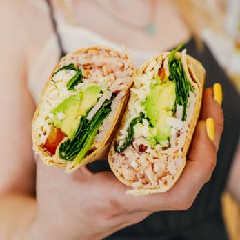 Beyond Juicery + Eatery - a woman holding a burrito - Salad Near Me - Grosse Pointe, Michigan Beyond Juicery + Eatery - a woman holding a burrito - Salad Near Me - Grosse Pointe, Michigan