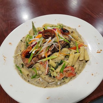 Mello Vibez Restaurant - a pasta dish on a white plate - Trinidadian Near Me - Boston, Massachusetts Mello Vibez Restaurant - a pasta dish on a white plate - Trinidadian Near Me - Boston, Massachusetts
