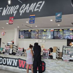 Touchdown Wings - Rather large inside & multi cashiers. Lots of ppl waiting in the lobby & sitting at the tables